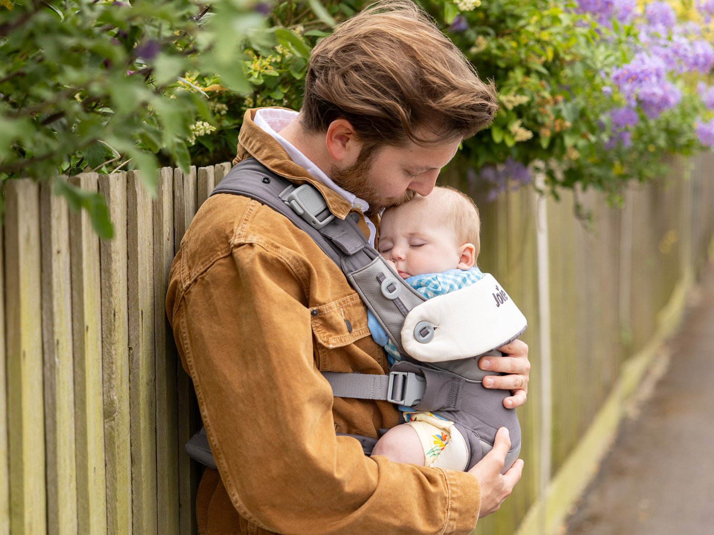 Sleeping baby in savvy lite 3-in-1 carrier on dad's front