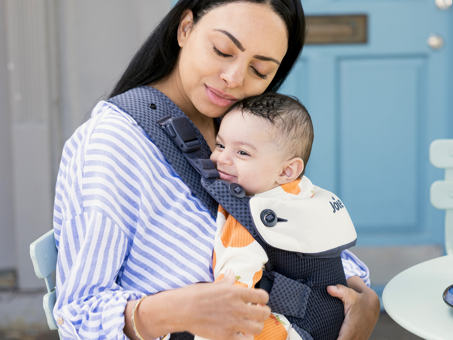 Baby in savvy lite air 3-in-1 carrier in indigo on mom's front