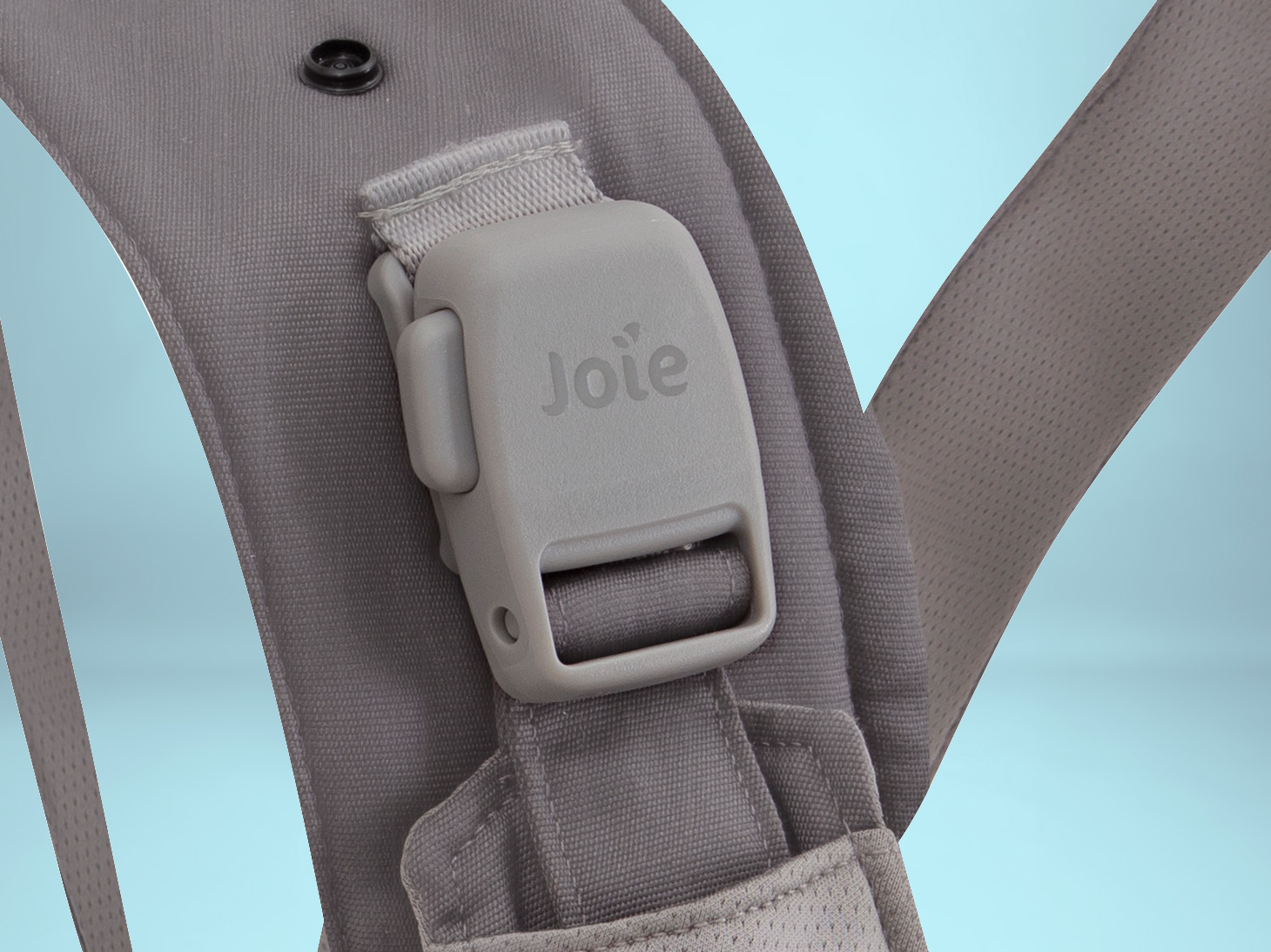 Close-up of shoulder buckle and strap of savvy lite 3-in-1 carrier on light blue background