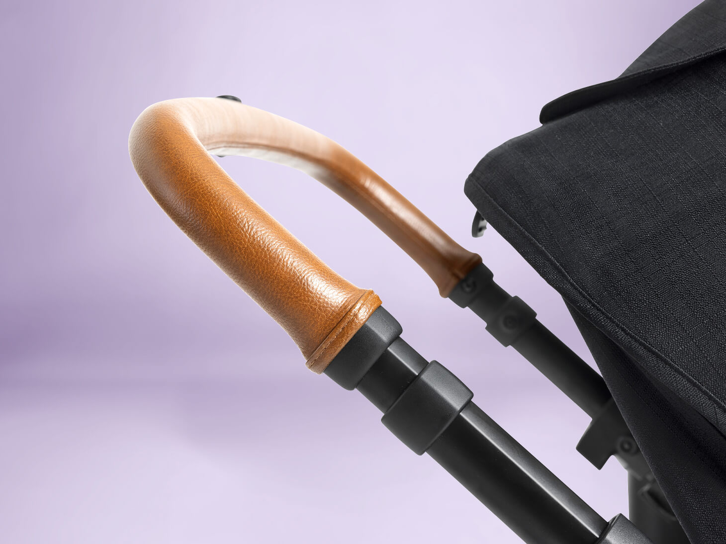 Close up of height-adjustable handle on Ginger 4-in-1 height adjustable stroller
