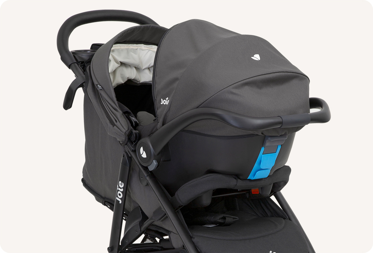 A black Joie Litetrax 4 travel system with the infant car seat attached to the stroller, facing toward the right in profile. 