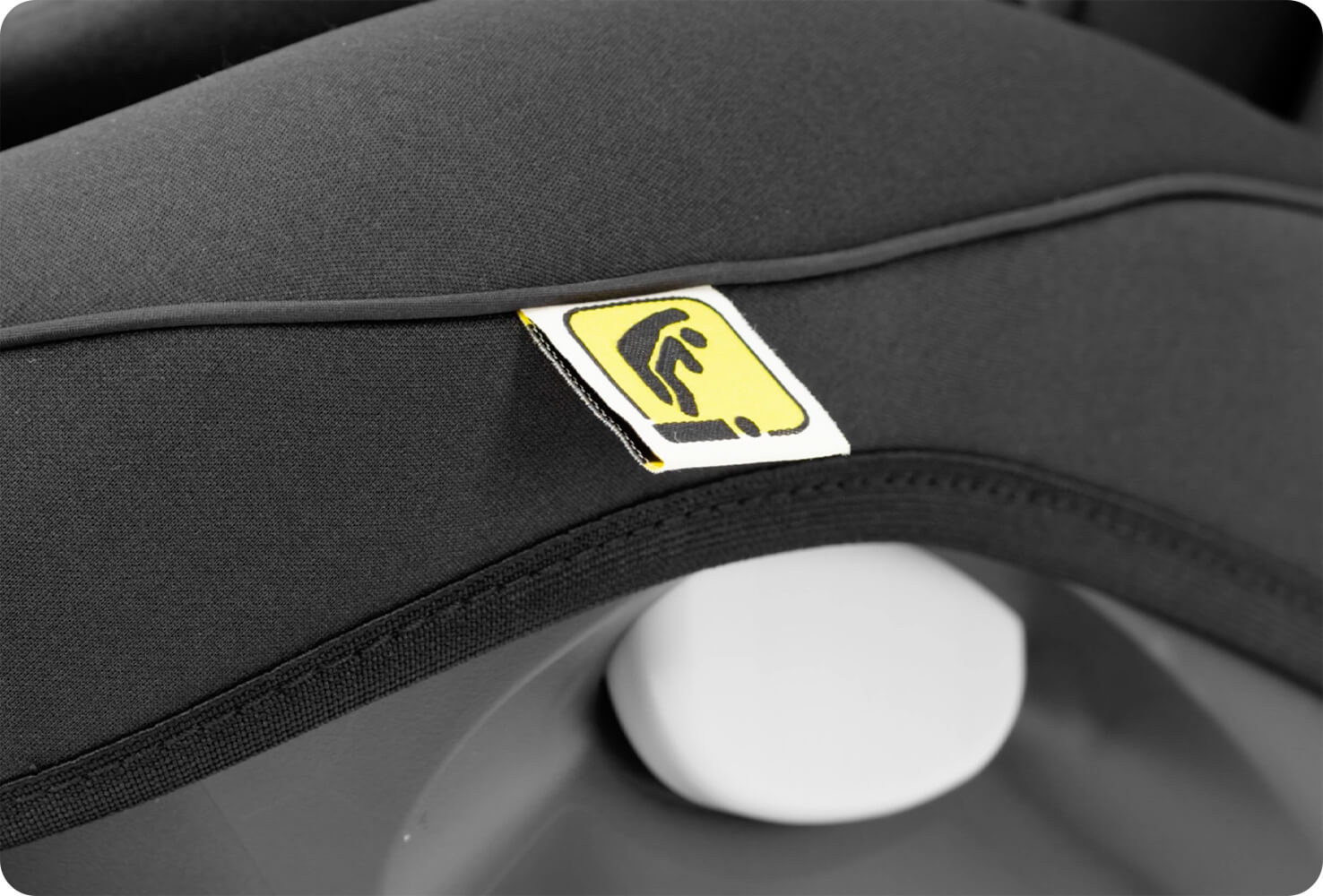 Closeup of I-Size tag on a black Joie I-Spin Safe r car seat