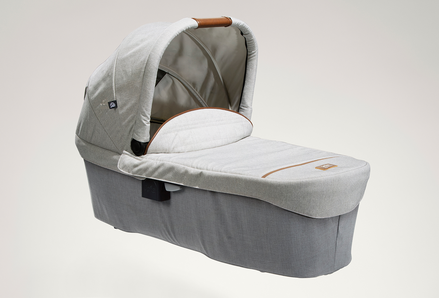 Gray Joie Signature Ramble XL carry cot facing toward the right at an angle.
