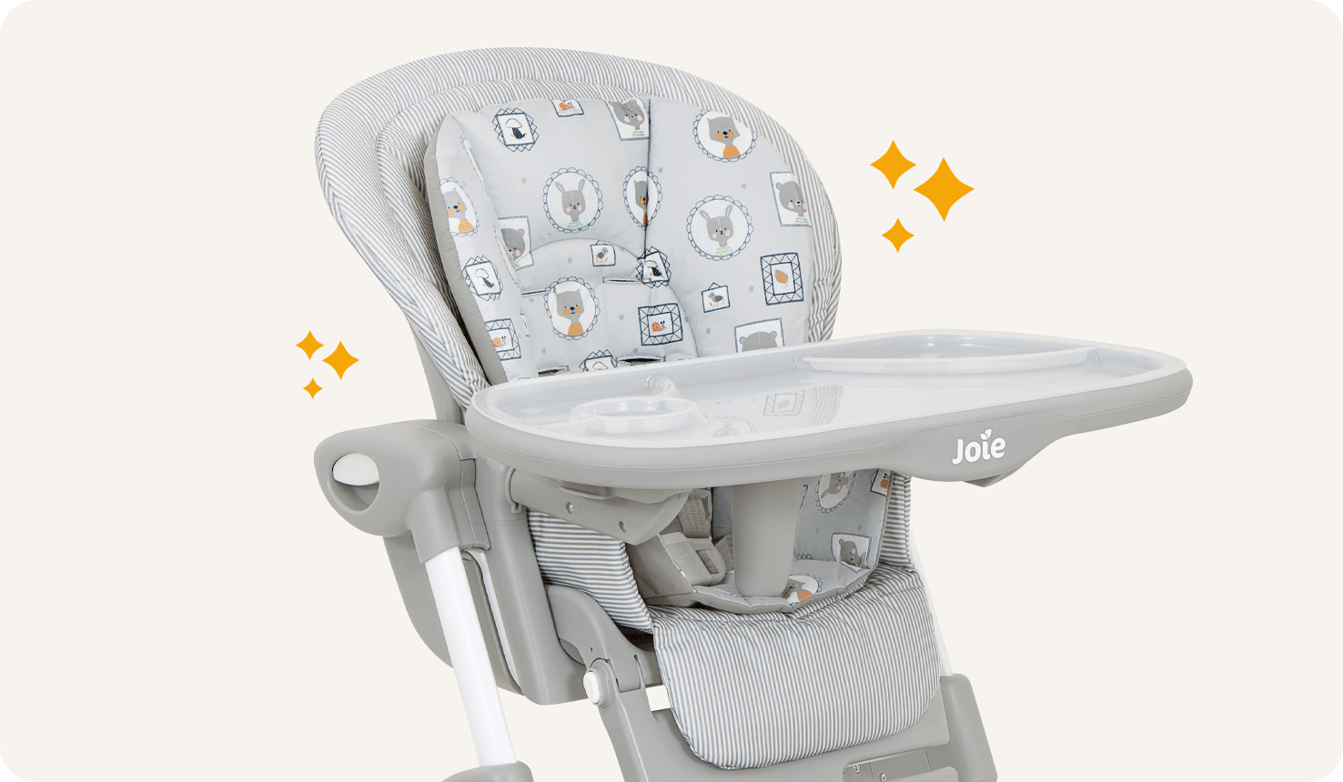 Closeup on a gray, black and white patterned Mimzy 2in1 highchair with orange star icons on either side.