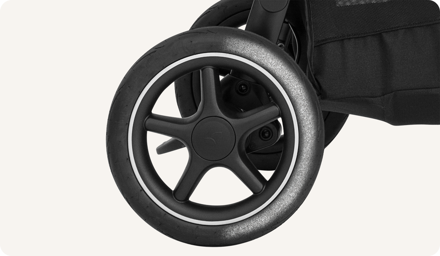 Zoomed in view of the wheel on a Joie versatrax pram.
