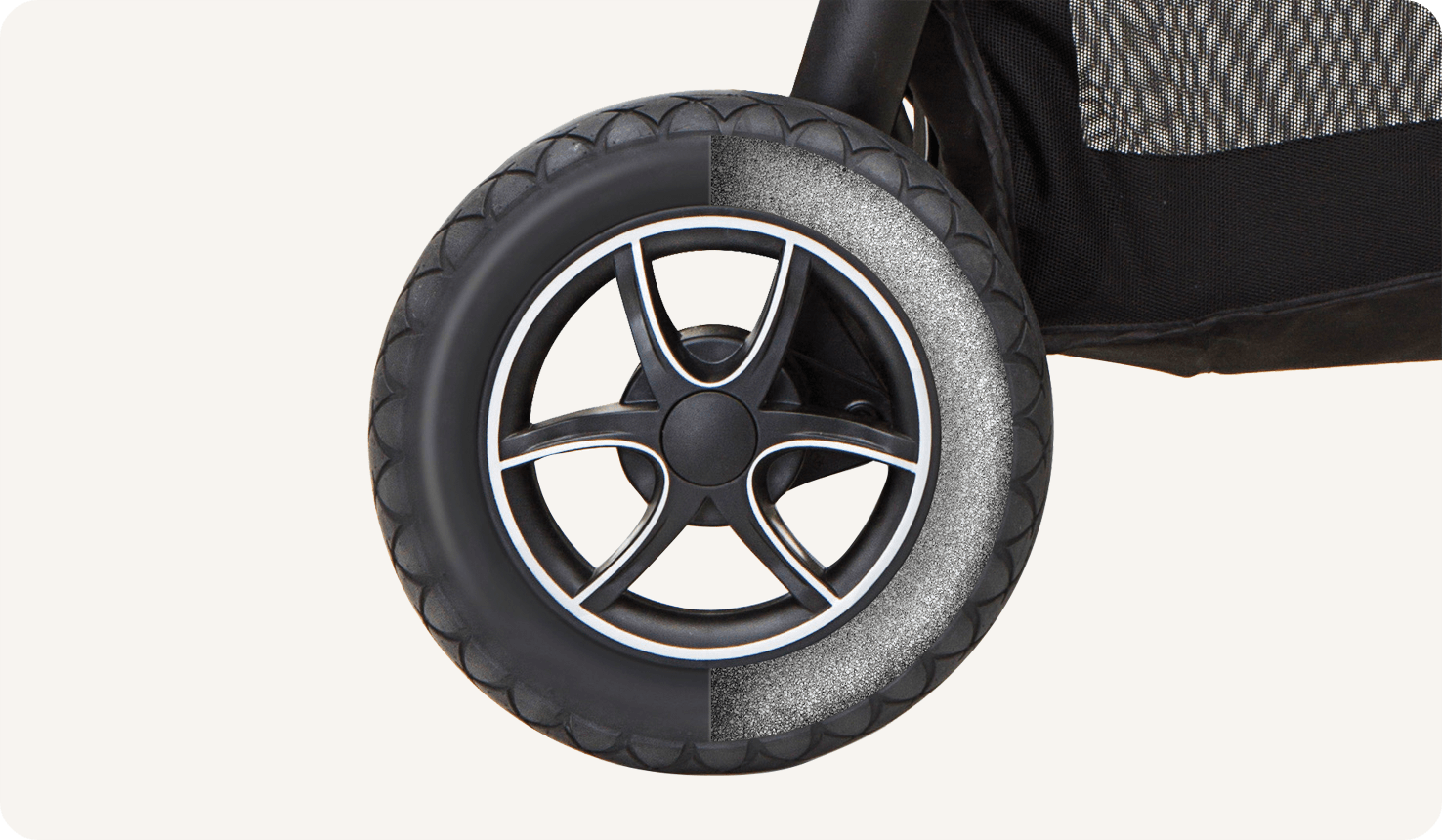 Zoomed in view of the wheel of the gray and black Joie versatrax pram.