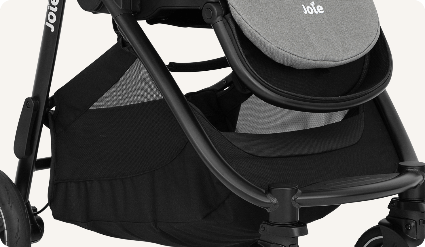 Zoomed in view of the storage basket on a Joie versatrax pram.
