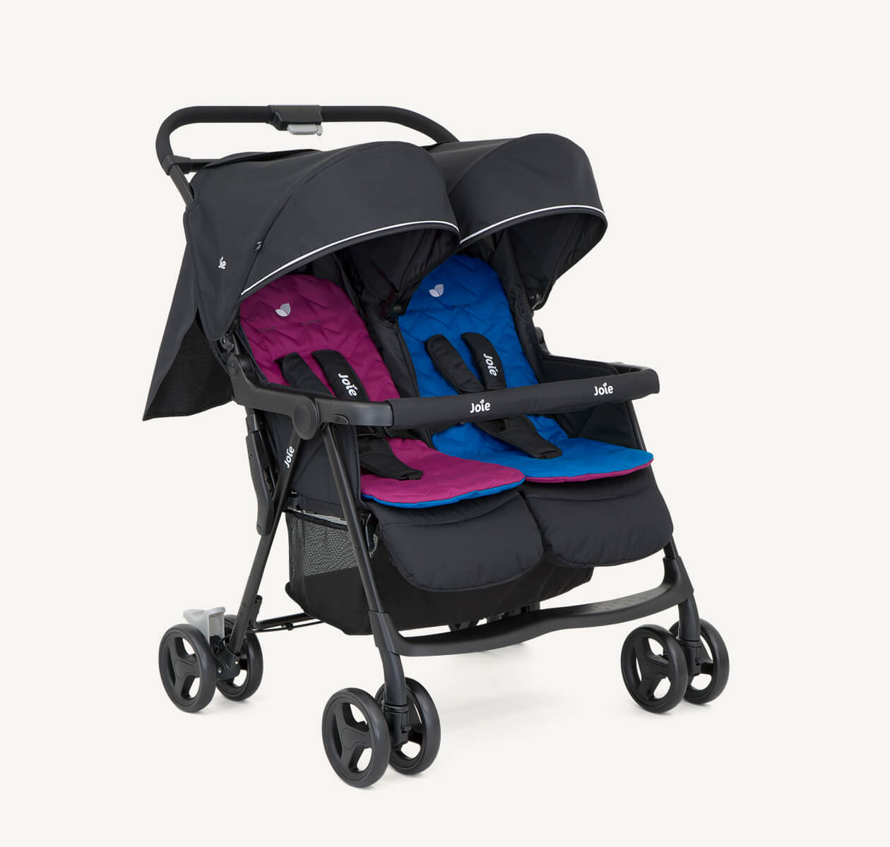  The Joie Aire Twin side-by-side double stroller in light gray at an angle, with a peach coloured seat insert on the left seat and a light blue insert on the right seat.