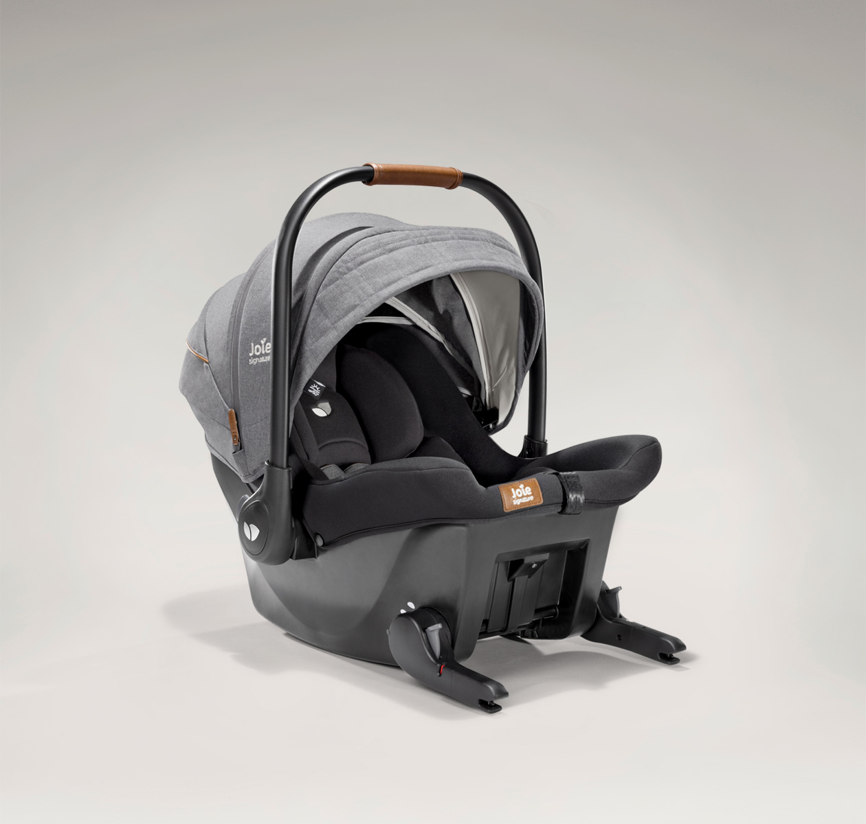 Joie signature's ISOFIX integrated infant carrier in gray and black at an angle 
