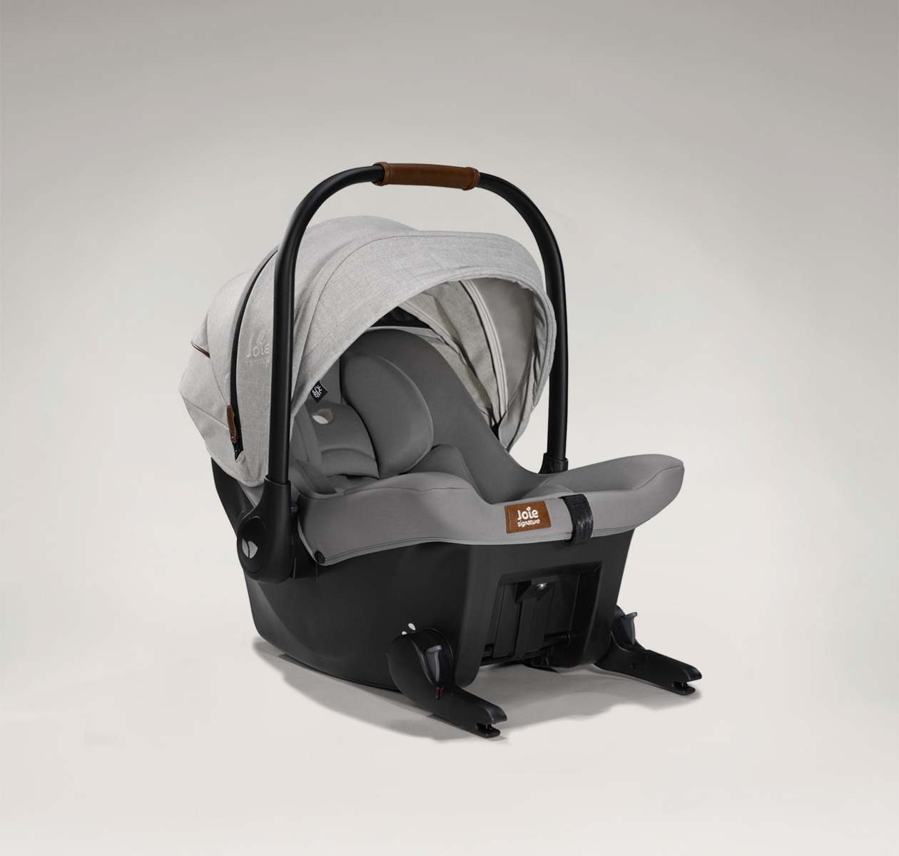 Joie signature's ISOFIX integrated infant carrier in gray at an angle ISOFIX lowered 
