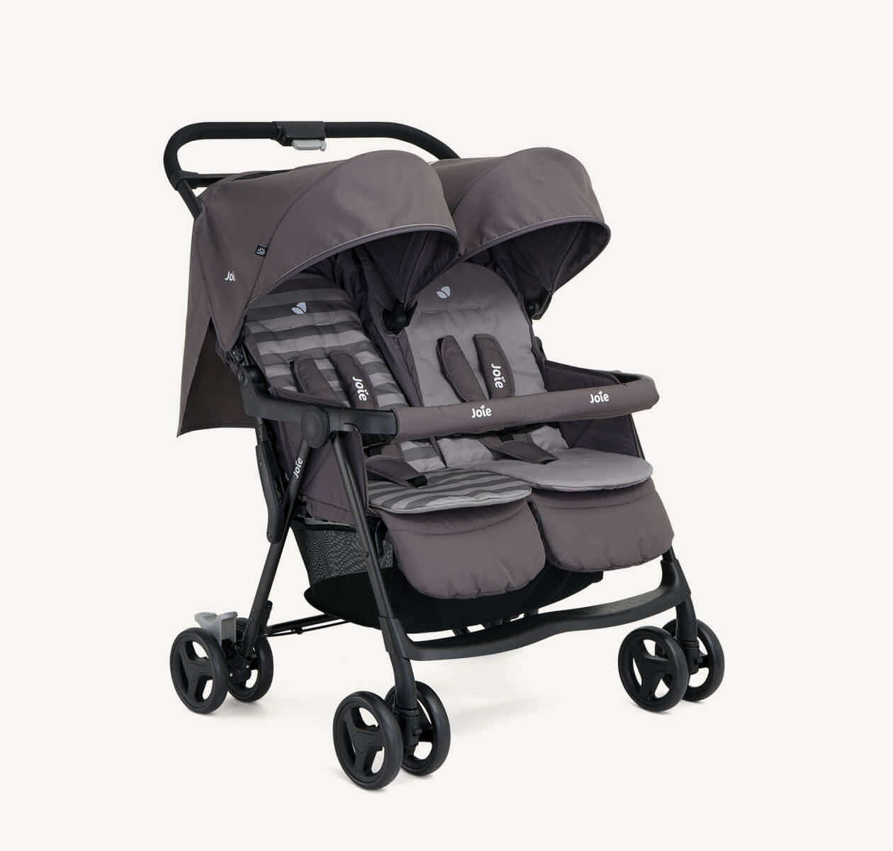  The Joie Aire Twin side-by-side double stroller in dark gray with two tone striped seat inserts, at an angle.