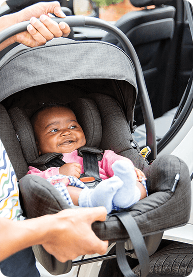 Young infant in the Joie i-Gemm infant carrier car seat