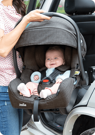 Young infant in the Joie i-Gemm infant carrier car seat