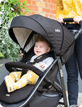 Image of a baby in a stroller being pushed by a mother. 