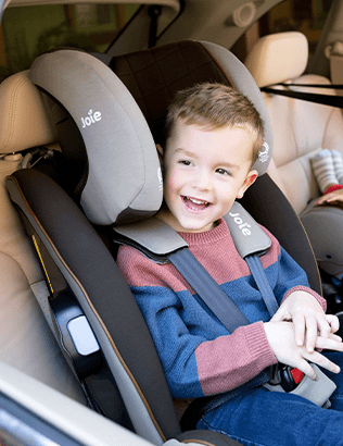 Toddler in the Joie armour FX spinning car seat